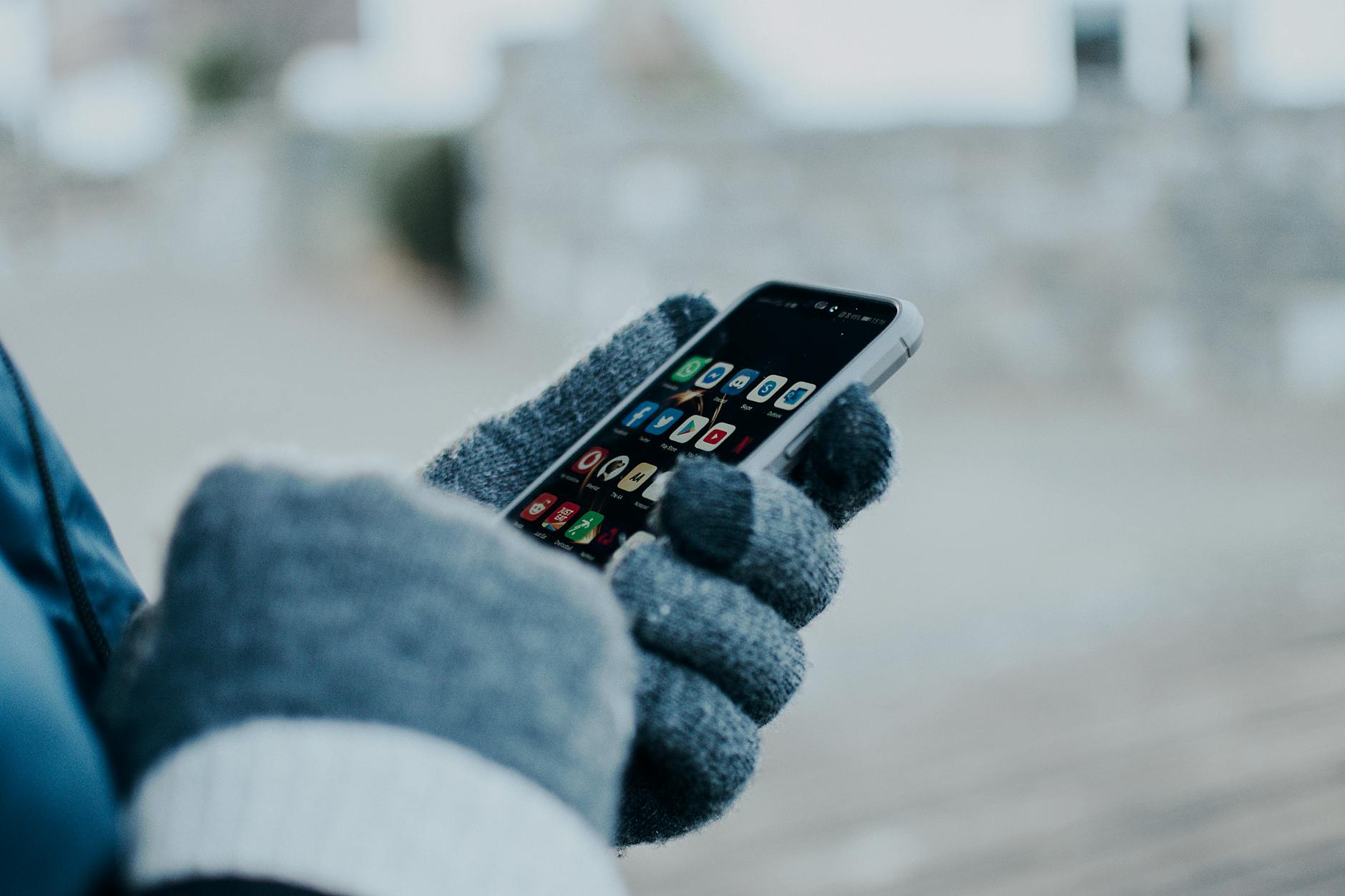 https://www.pexels.com/photo/person-wearing-gloves-holding-a-cellphone-3473411/